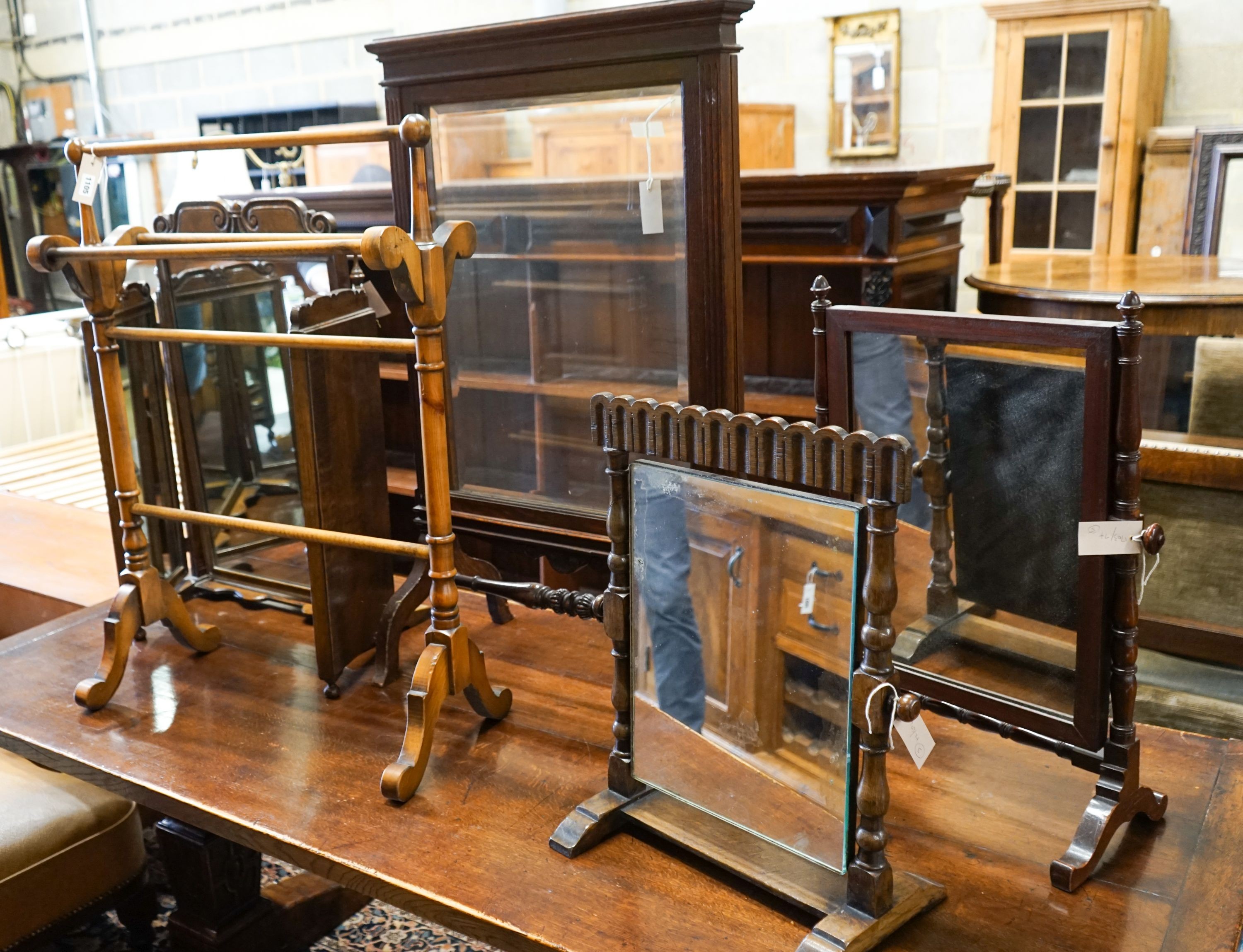 An oak triple mirror, a towel rail, an oak firescreen and two toilet mirrors